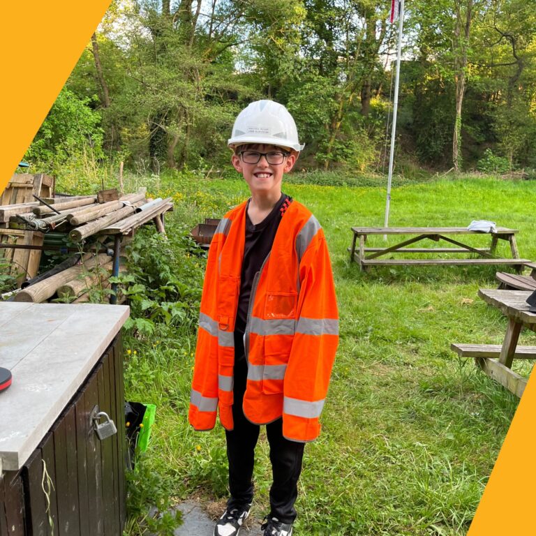 Scouts experience surveying with hands on field work activity. scout wears the malcolm hughes high vis and hard hat