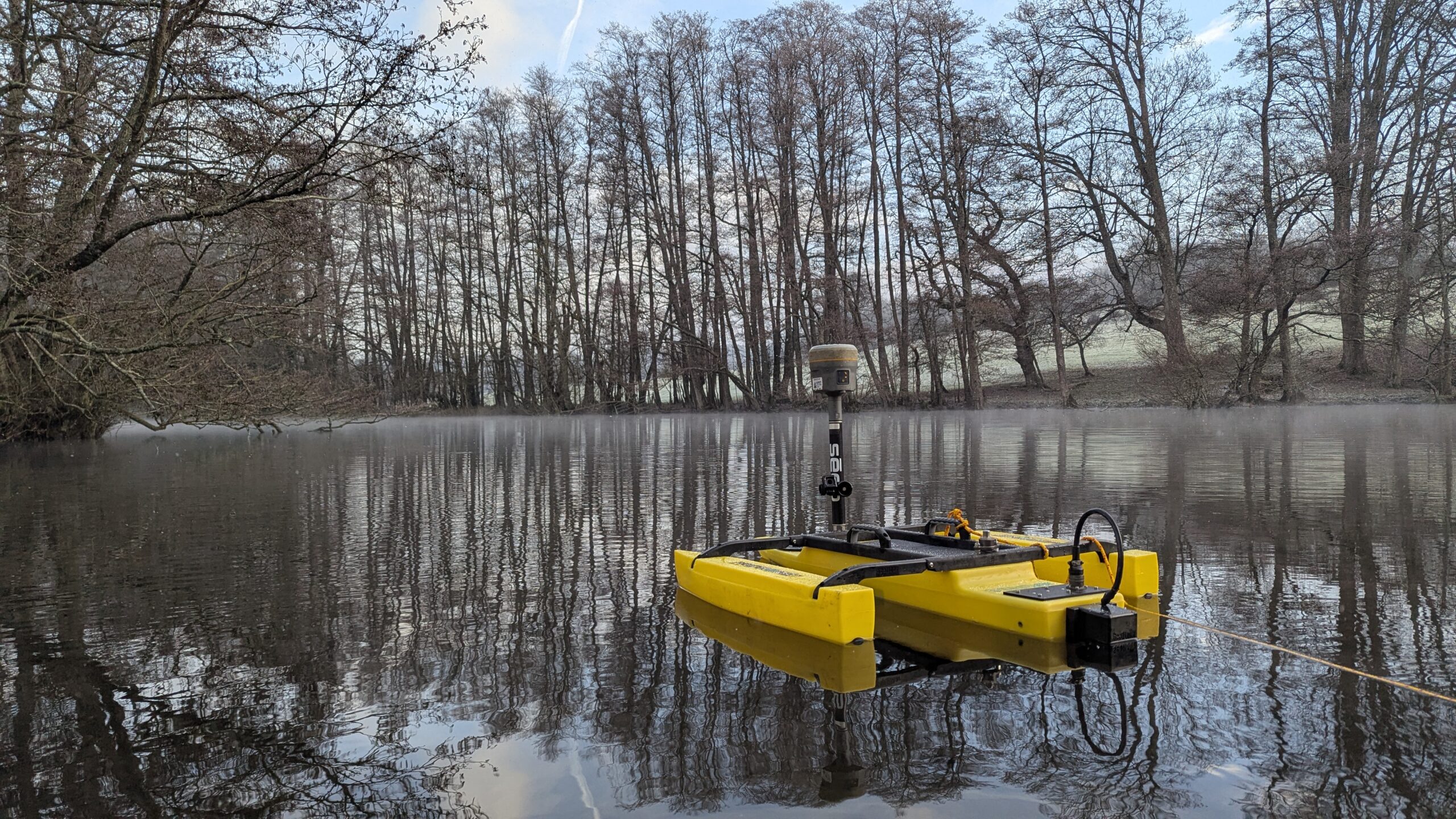 Malcolm Hughes Surveyor in water with a TriDrone conducting a hydrographic Survey
