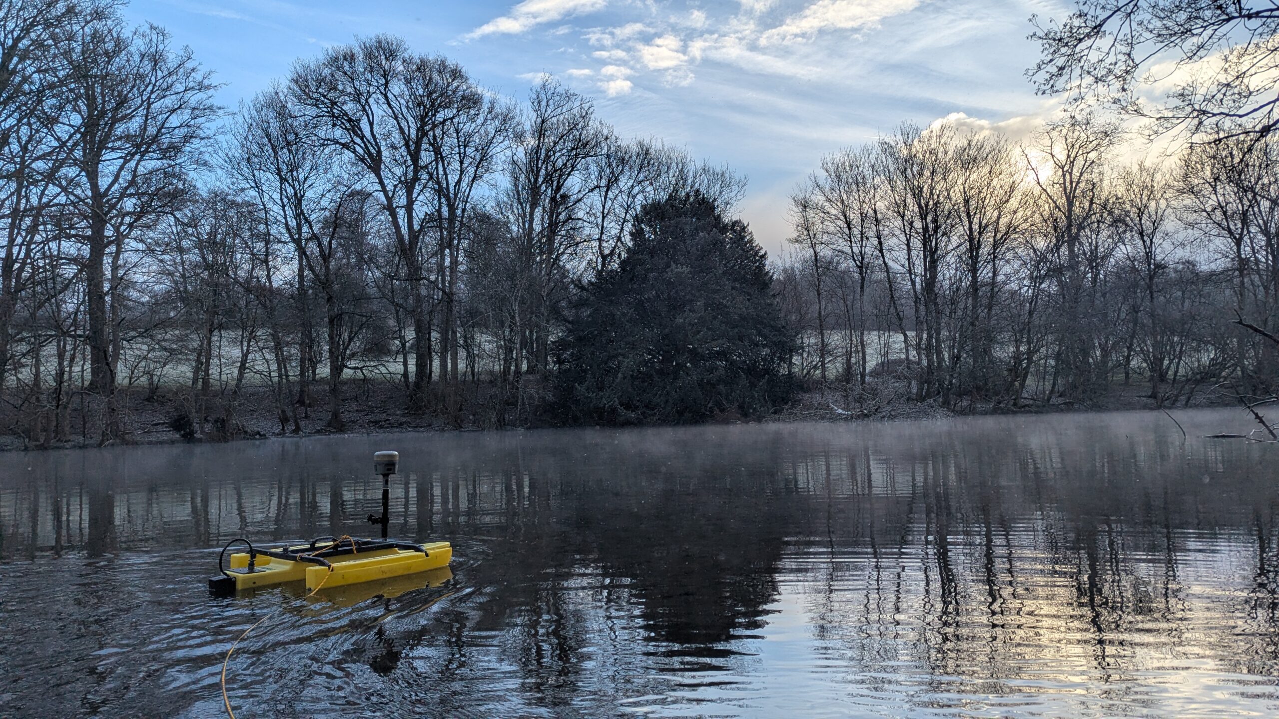 Malcolm Hughes Surveyor in water with a TriDrone conducting a hydrographic Survey