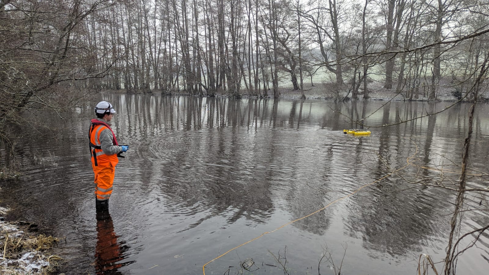 Malcolm Hughes Surveyor in water with a TriDrone conducting a hydrographic Survey